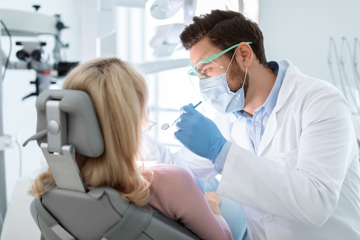 Dentist helping patient